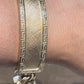 CHINO BRACELET WITH ST. JUDE ON TWO PLATES AND GREEK KEY BORDER ON ALL THREE PLATES, CENTER PLATE PLAIN 77.40 GM